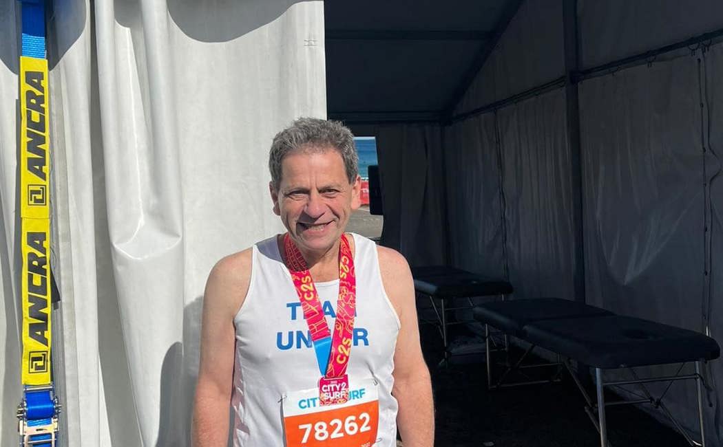 Community fundraiser, Bernie smiles at camera after completing the City to Surf in Sydney.