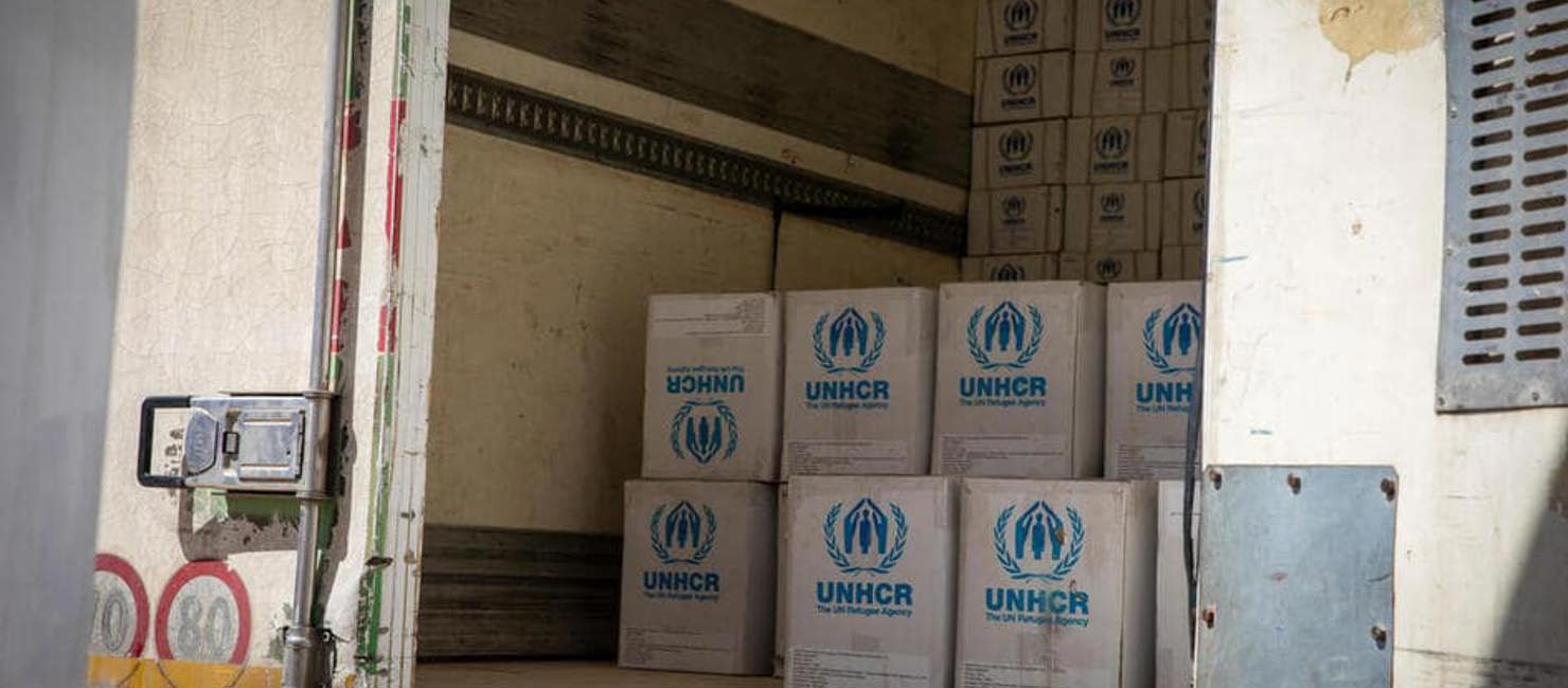 A truck containing UNHCR flood relief items is prepared to depart from Tripoli for Benghazi, Libya, where tarpaulins, hygiene kits and plastic sheets will be distributed in areas affected by Storm Daniel. 