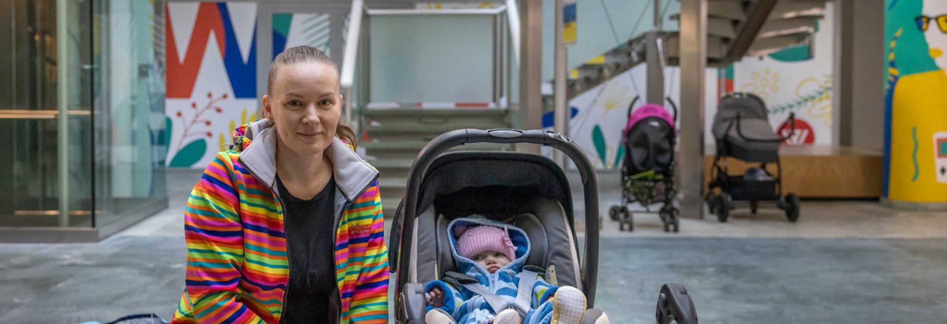 Ukrainian refugee Hanna, 38, and her baby at an aid distribution point run by UNHCR partner Mother's House Foundation in Warsaw, Poland.