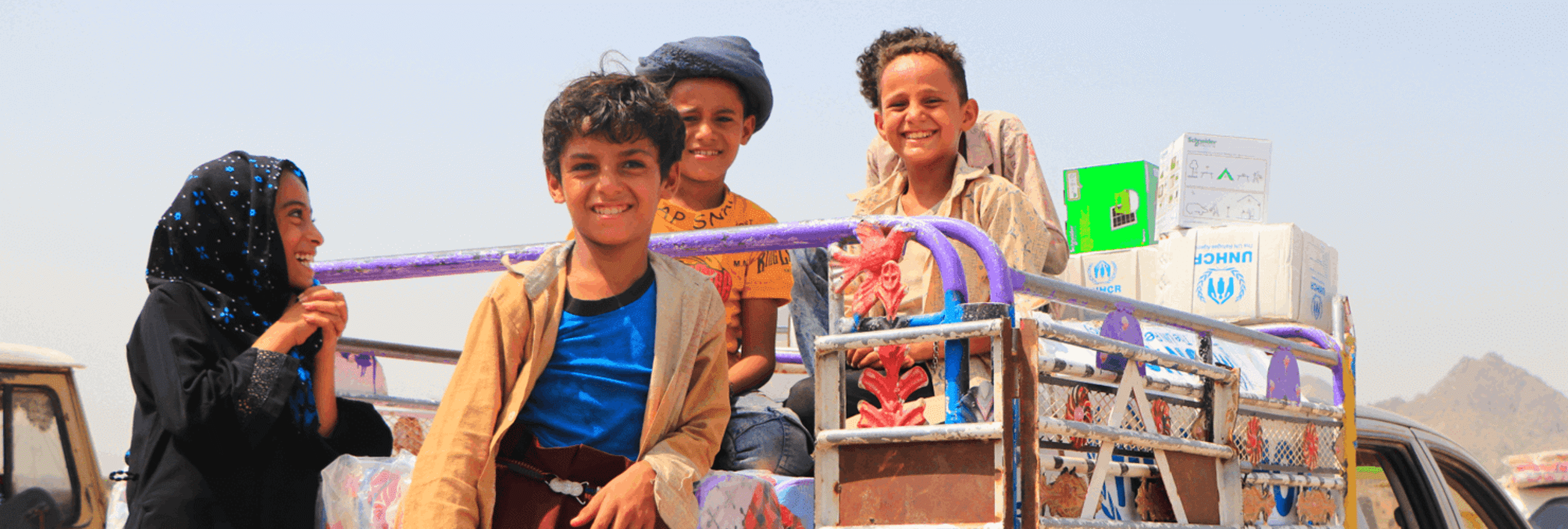 Banner Yemen Children On Truck With Unhcr Supplies (1)