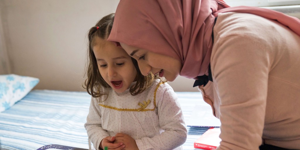 Hevin, a 30-year-old mother of three from Aleppo, with her daughter Selin inside their home in Istanbul.
