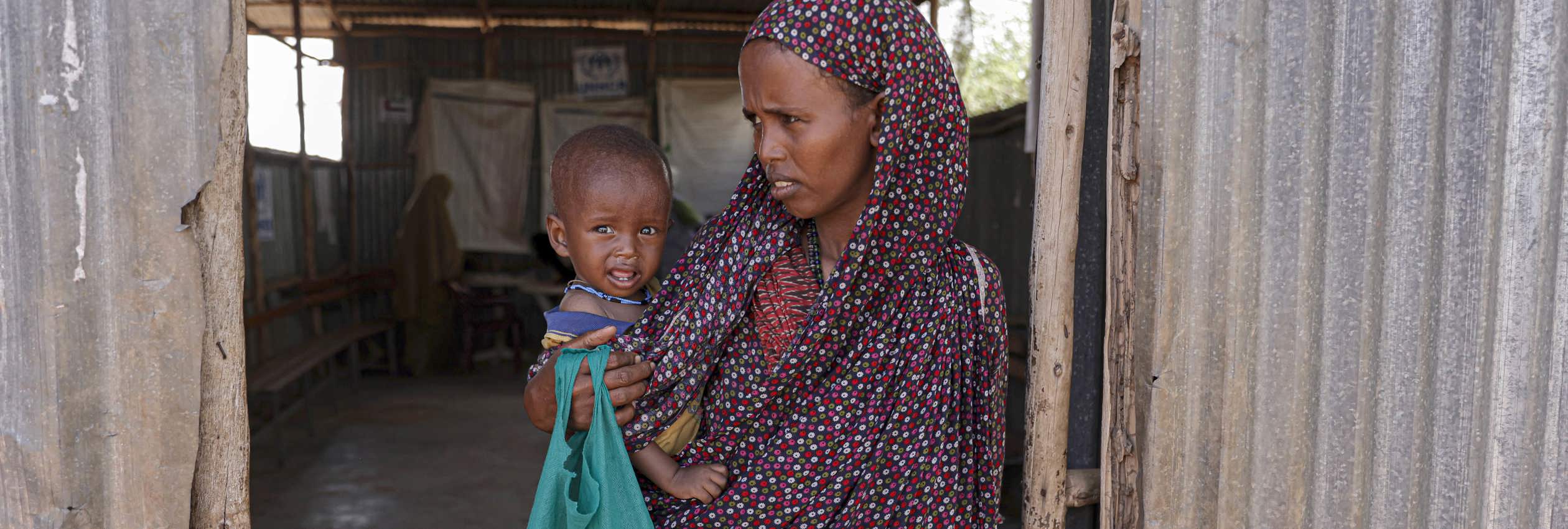 Samira Abdi, 28 waits to receive food and treatment for her malnourished child at the Melkadida UNHCR supported food distribution centre in Melkadida