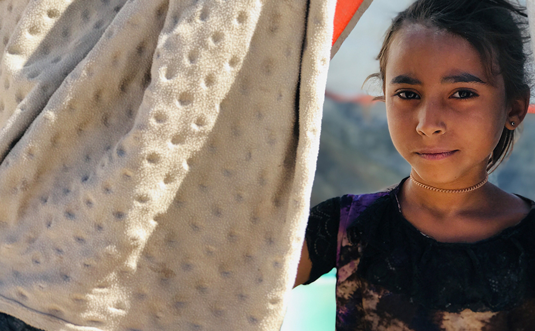 A young girl faces camera © UNHCR/Arwa Al Sabri
