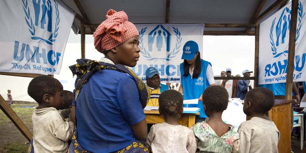 Congolese internally displaced family sits with UNHCR staff while going through the registration process at Kibati IDP site to be transfered by the UNHCR along with other vulnerable families to the Mugunga I site