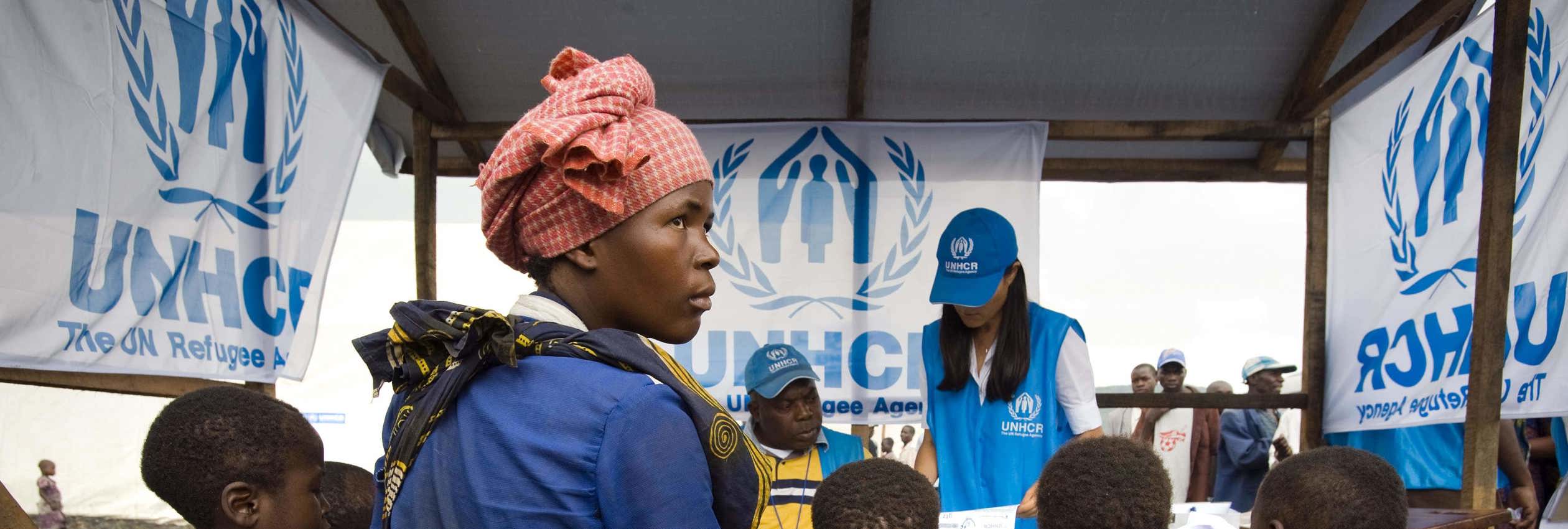 Congolese internally displaced family sits with UNHCR staff while going through the registration process at Kibati IDP site to be transfered by the UNHCR along with other vulnerable families to the Mugunga I site