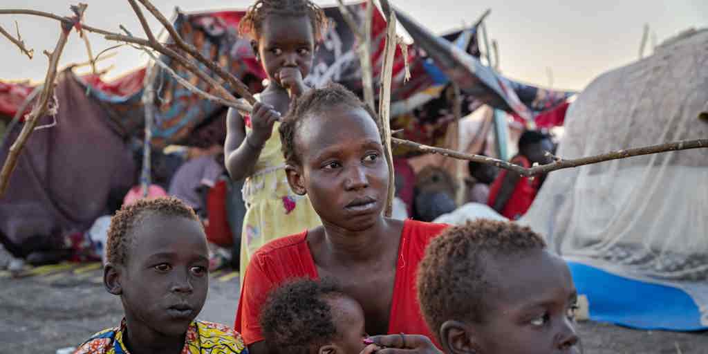 Eliza sits with her children at the UNHCR transit centre in Renk, South Sudan