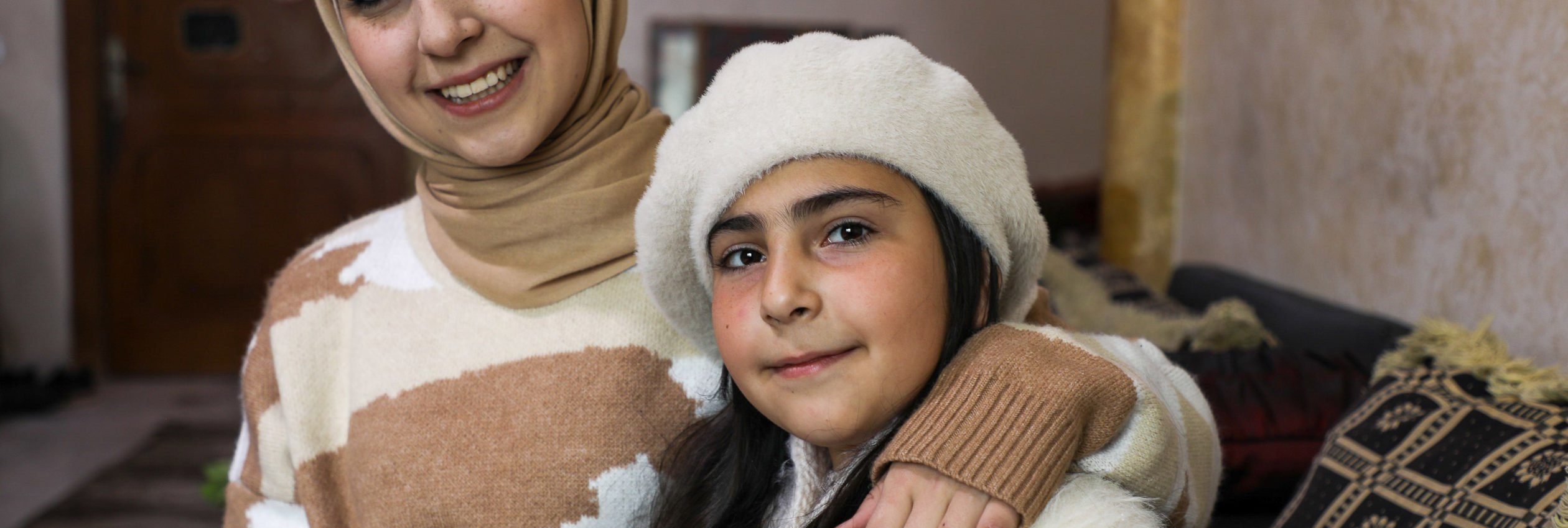 Aya, 20, a Syrian refugee in Jordan is pictured with her younger sister Turkia, 10.