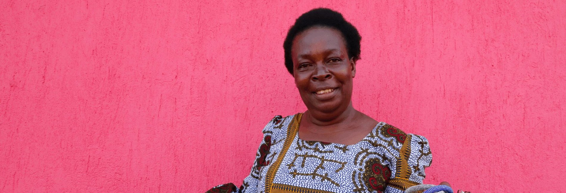 Gloria, a Congolese refugee in Uganda, shows off her brightly coloured handicrafts