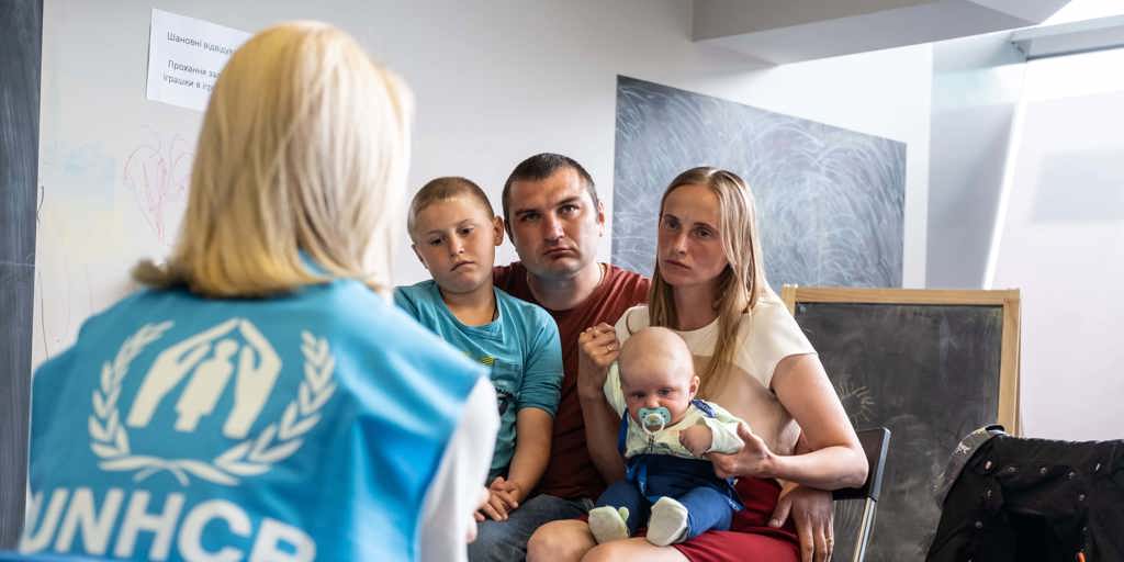 Ukrainian refugees, Andrei and Ludmila, visit UNHCR’s cash enrolment centre in Krakow Tauron Arena to register for cash assistance to cover their basic needs.