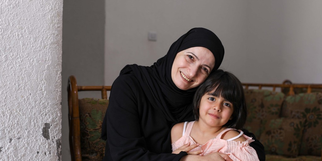 Ghada, a Syrian refugee and entrepreneur is pictured at home with her youngest daughter Sham, 4.