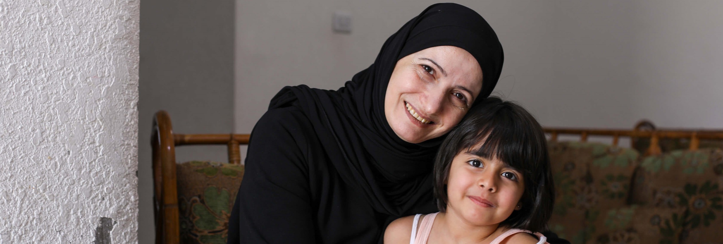 Ghada, a Syrian refugee and entrepreneur is pictured at home with her youngest daughter Sham, 4.