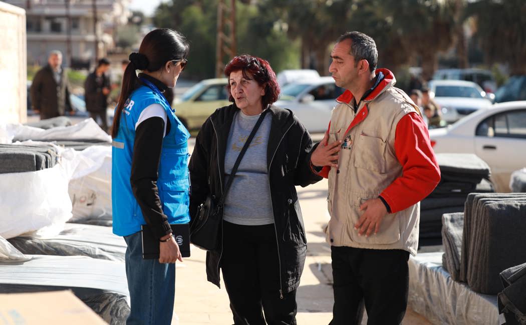 A UNHCR staff member meets Aziza and her son, who has special needs, who fled their home after the earthquakes struck south-eastern Türkiye and northern Syria on 6 February.