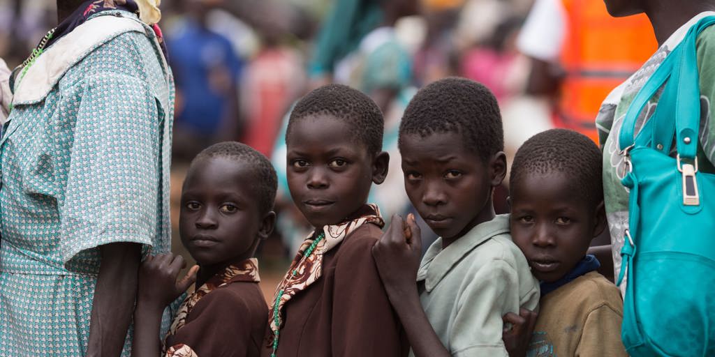 South Sudanese refugee children wait in line to be registered at a UNHCR collection point in Elegu, Uganda.