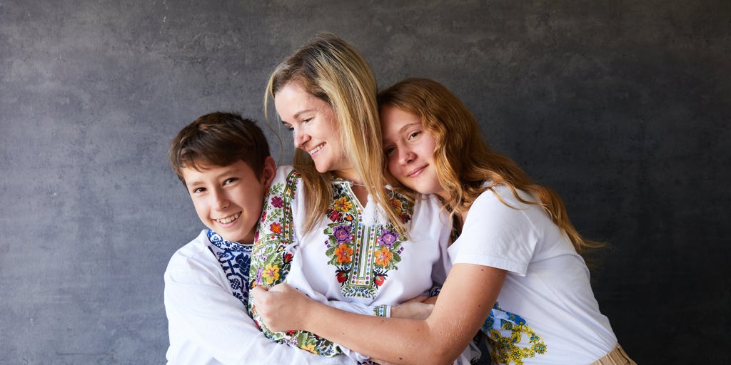 riia Mykytiuk (centre) with her children, Kyrylo and Anastasiia, share two of their favourite Ukrainian pancake dishes - syrniki and deruny. 