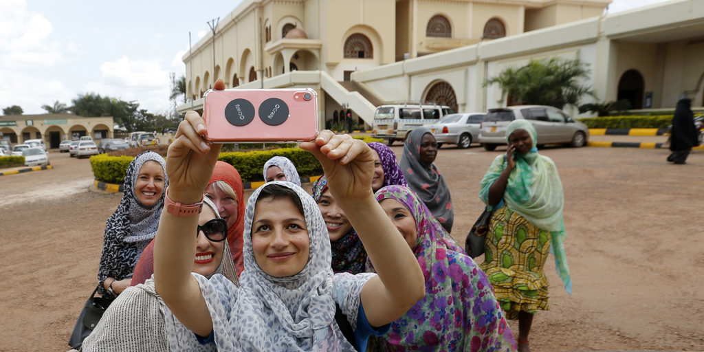 Zoe Ghani takes a selfie with women in Uganda