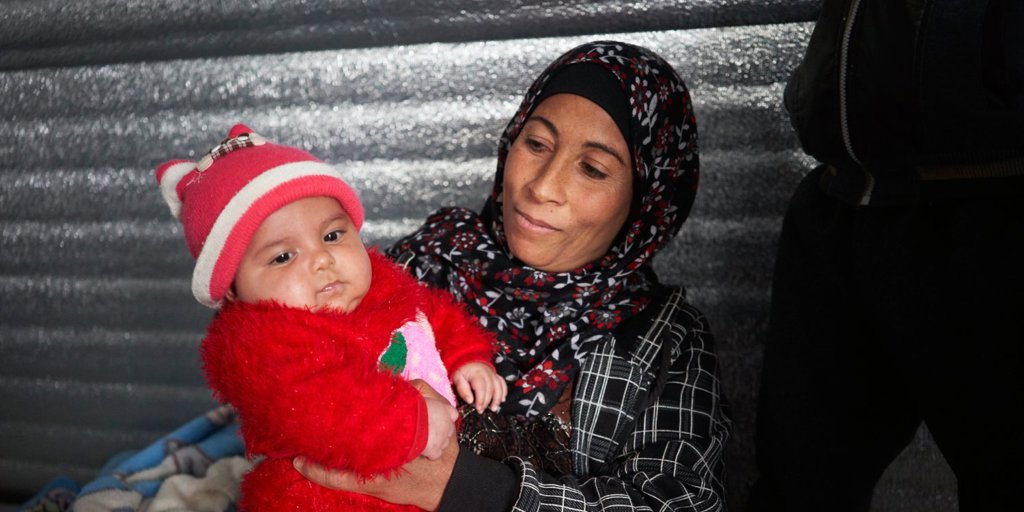 Wardah Alabdallah holds her two-month-old daughter Muna in the family's shelter in Azraq refugee camp, Jordan.