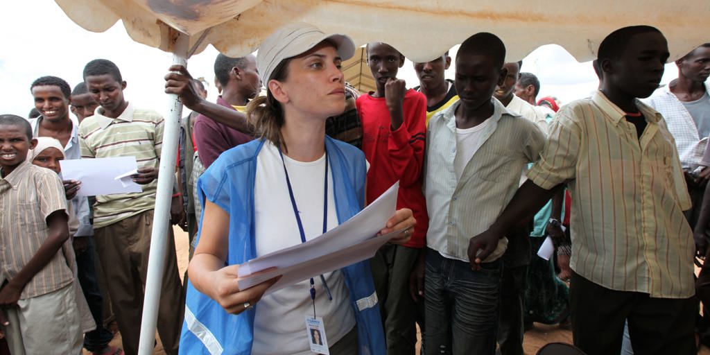 A UNHCR staff processes Somali refugee families registering at the reception centre at the Ifo camp within the Dadaab refugee camps in northern Kenya near the Somalia border