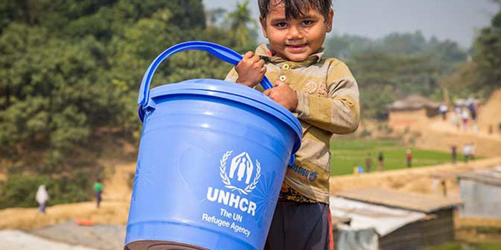 Young Rpohingya boy collecting water in his UNHCR bucket in Bangladesh | Ramadan charity gifts