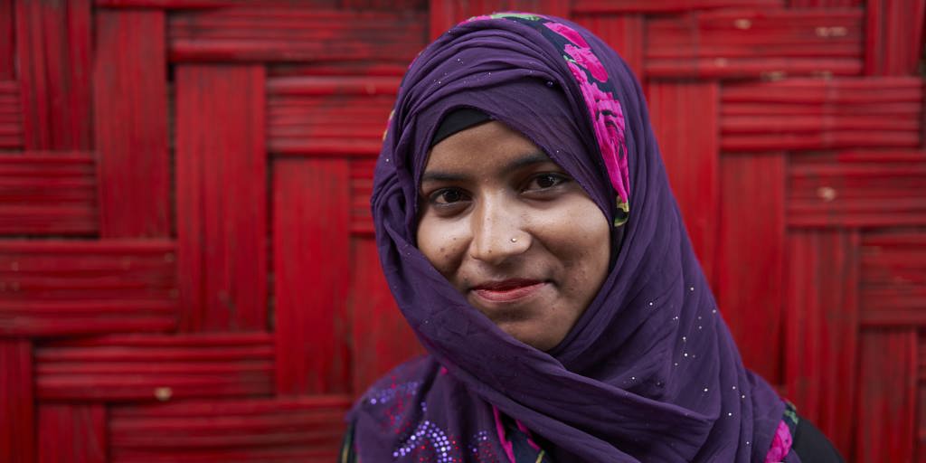 Rozaina Akhtar, 18, poses for a photograph outside the Dream Garden Adolescent Club, a safe space for Rohingya refugee women between the ages of 15-24, where she is one of the co-facilitators, in Camp 4, at the Kutupalong Expansion Site for Rohingya refugees, Ukhia, Cox's Bazar District, Bangladesh.