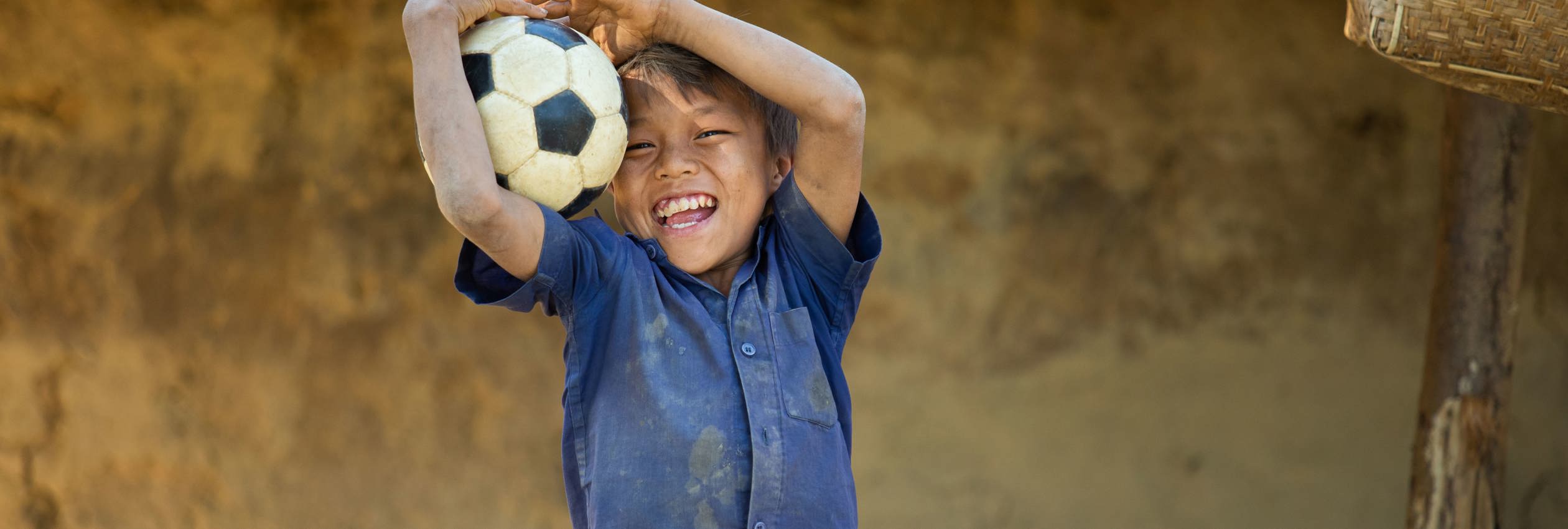 Young boy holds soccer ball 