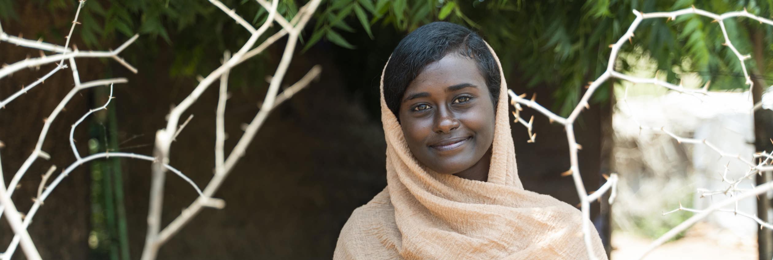 Islam, 21, was uprooted by conflict in Khartoum and now shelters at a refugee camp. 