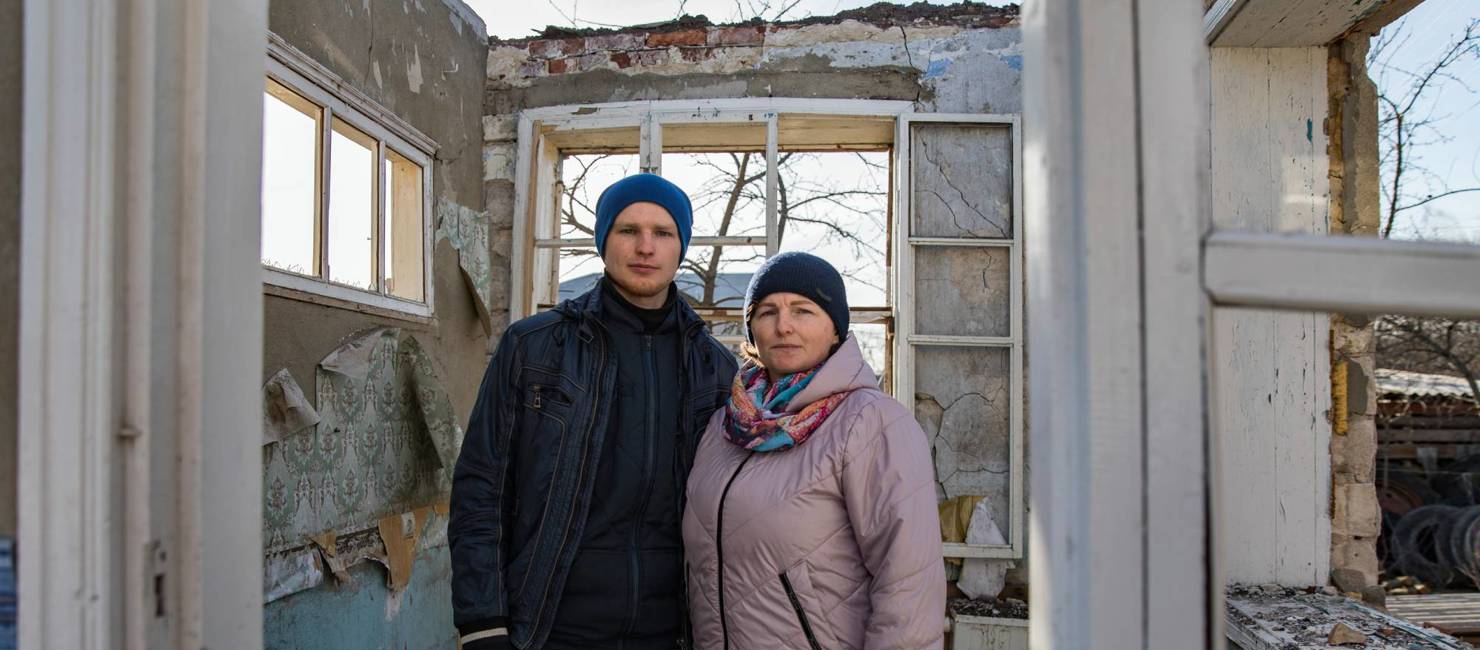 Halyna and her son, Vitali, stand in the remains of their family home which was badly damaged by a missile strike in Vinnytsia, Ukraine.