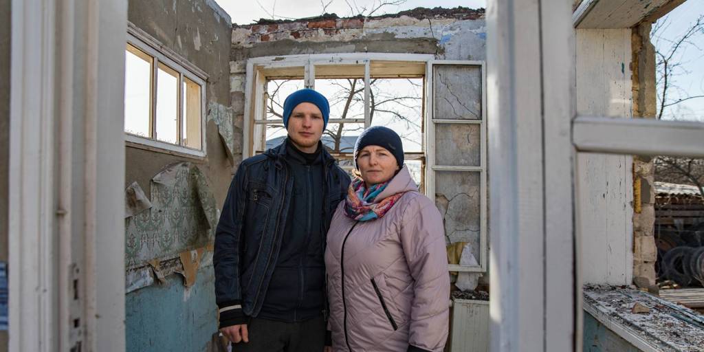 Halyna and her son, Vitali, stand in the remains of their family home which was badly damaged by a missile strike in Vinnytsia, Ukraine.