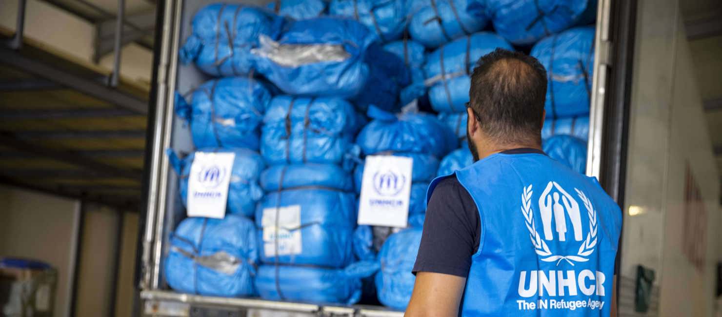 UNHCR staff load trucks with flood relief items for transportation from Tripoli to Benghazi, Libya, where tarpaulins, hygiene kits and plastic sheets will be distributed in areas affected by Storm Daniel.
