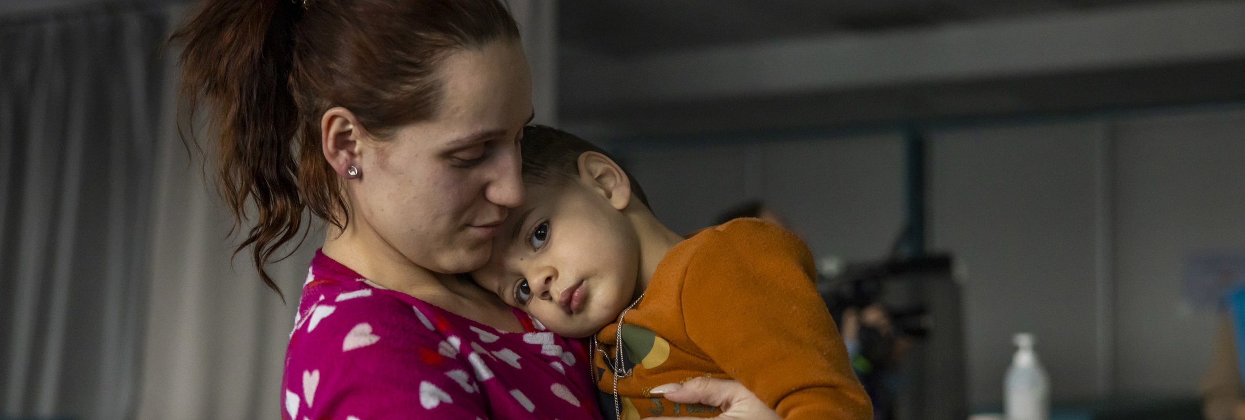 Refugee from Ukraine Katerina holding her son Arsen.