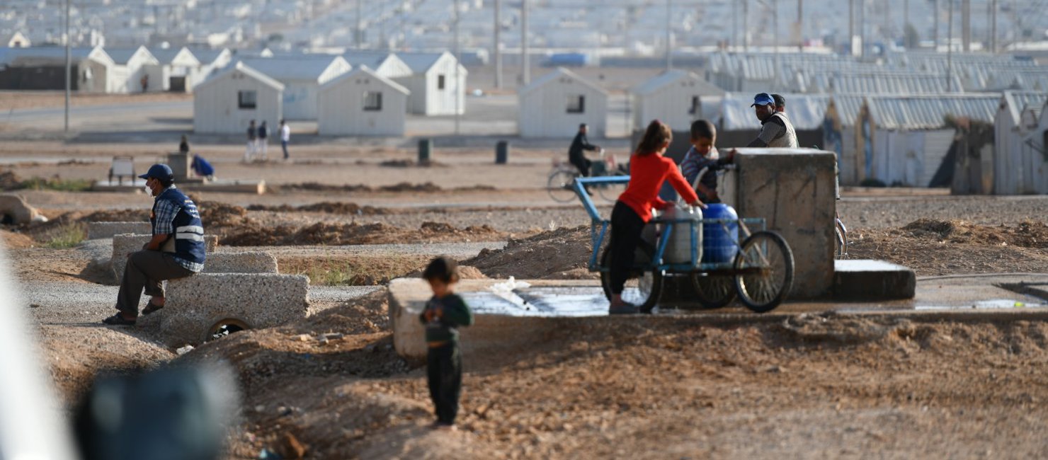 Refugees collect water in Azraq camp in Jordan.