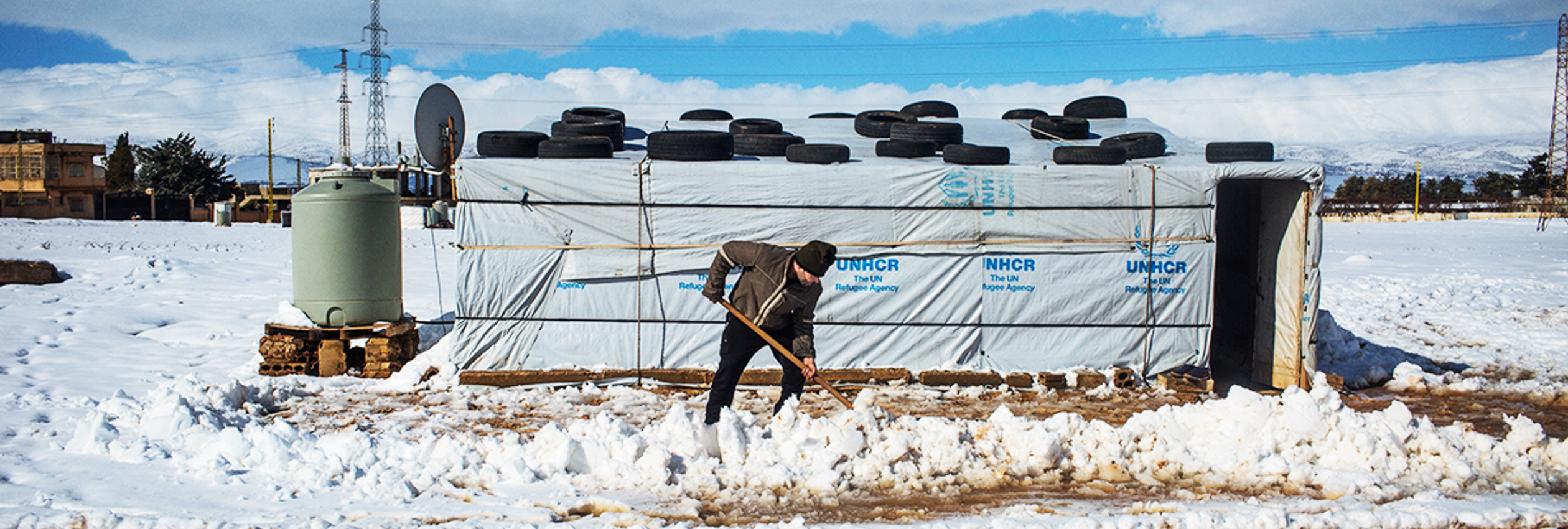 Ahmed, a Syrian refugee from Raqqa, removes snow with a shovel outside his home in the informal settlement camp of Doures, Lebanon. @UNHCR/ Shabia Mantoo