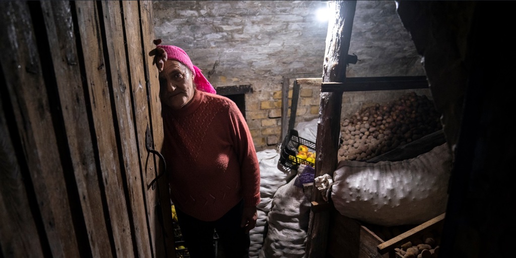 Liudmyla, 70, stands in her potato cellar, where she sheltered for a month during intense fighting.