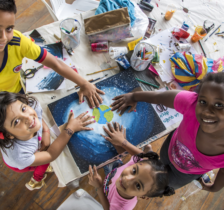 Ecuador. Young Refugees And Locals Paint Together