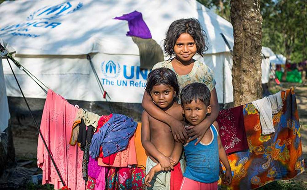 Young children outside their UNHCR shelter in Bangladesh | Ramadan charity gifts