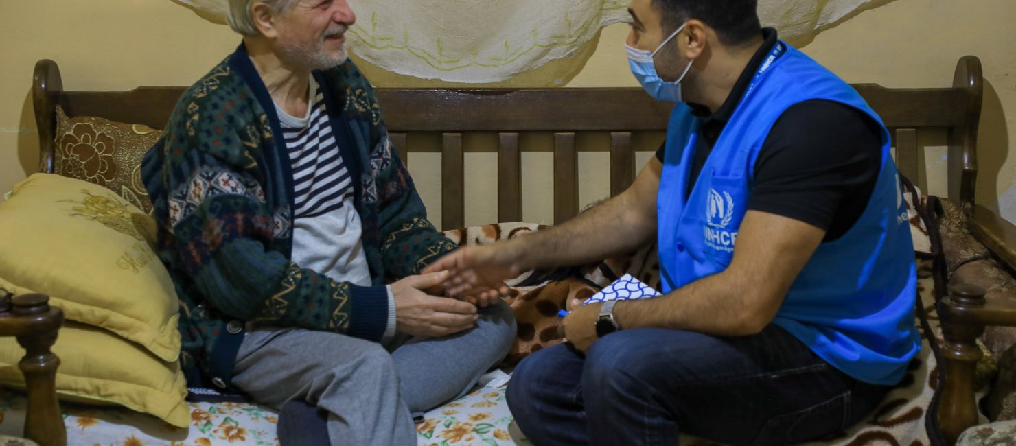 UNHCR staffer speaks with refugee. Elderly Syrian refugees suffer during Ramadan in Jordan.