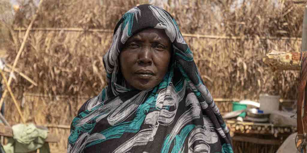 Ethiopia. Hawa, 40, stands in front of her shelter at the Kurmuk transit centre