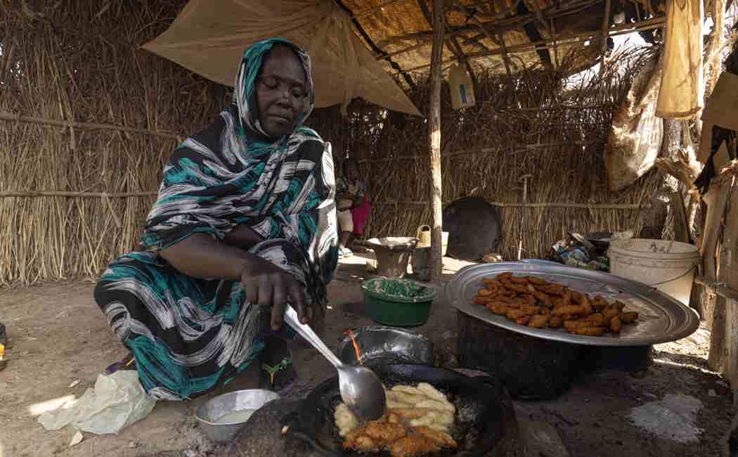 Hawa cooks falafel which she sells to buy soap and food for her children, Ethiopia
